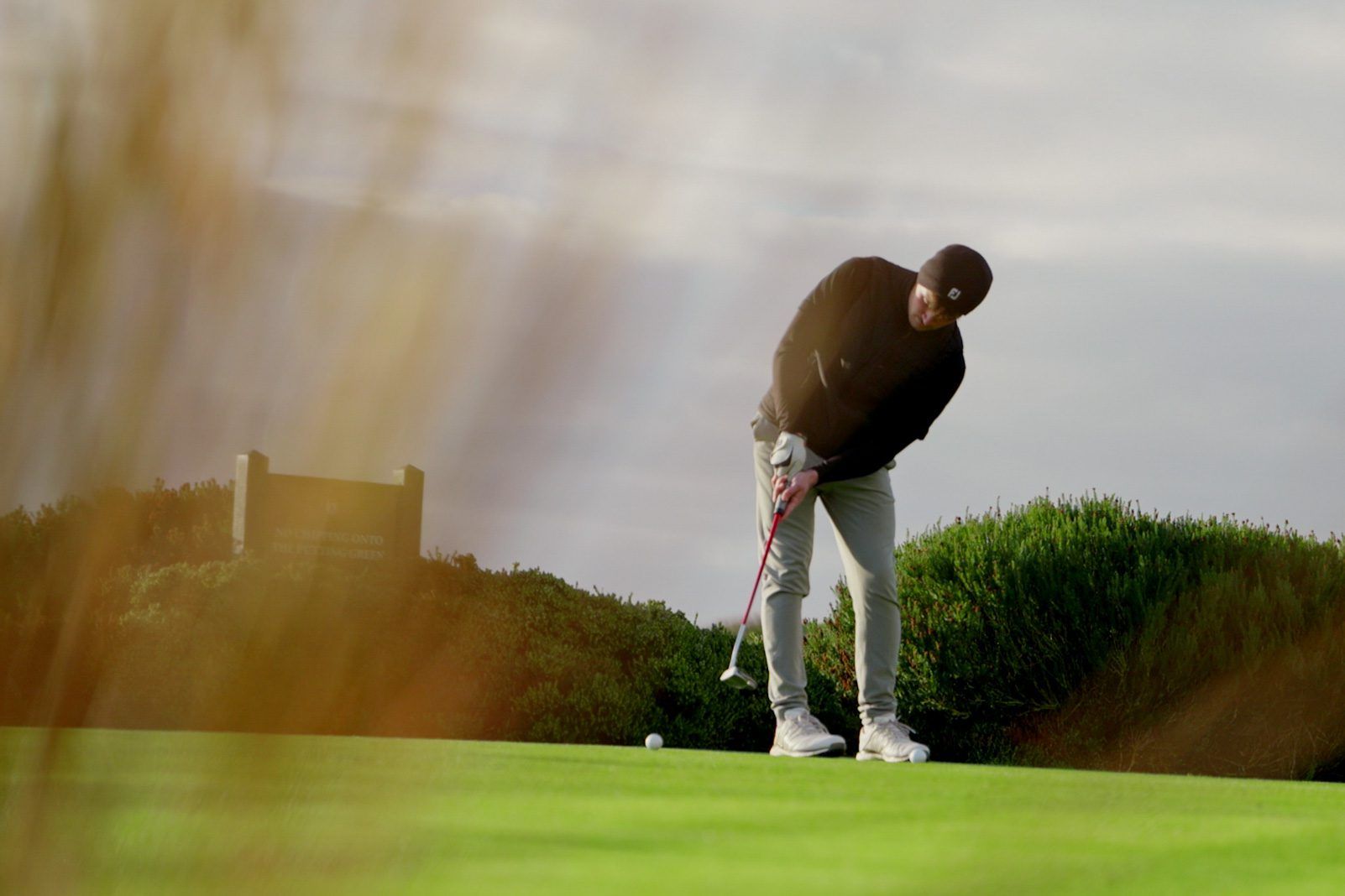 Man putting on green