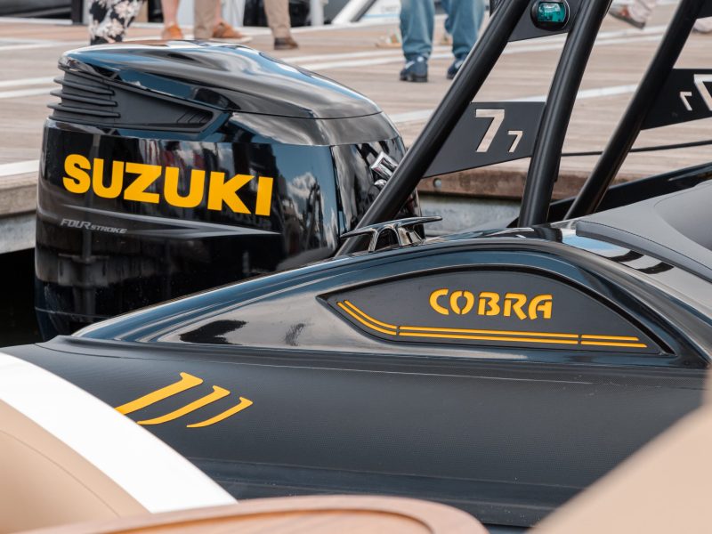 Engine and back end of RIB boat moored at pontoon
