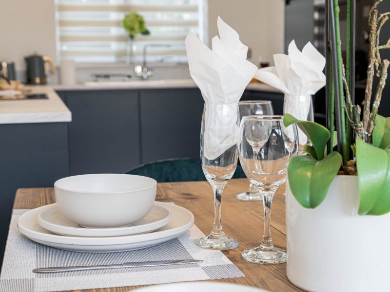Table setting with plates and wine glasses in dinning room